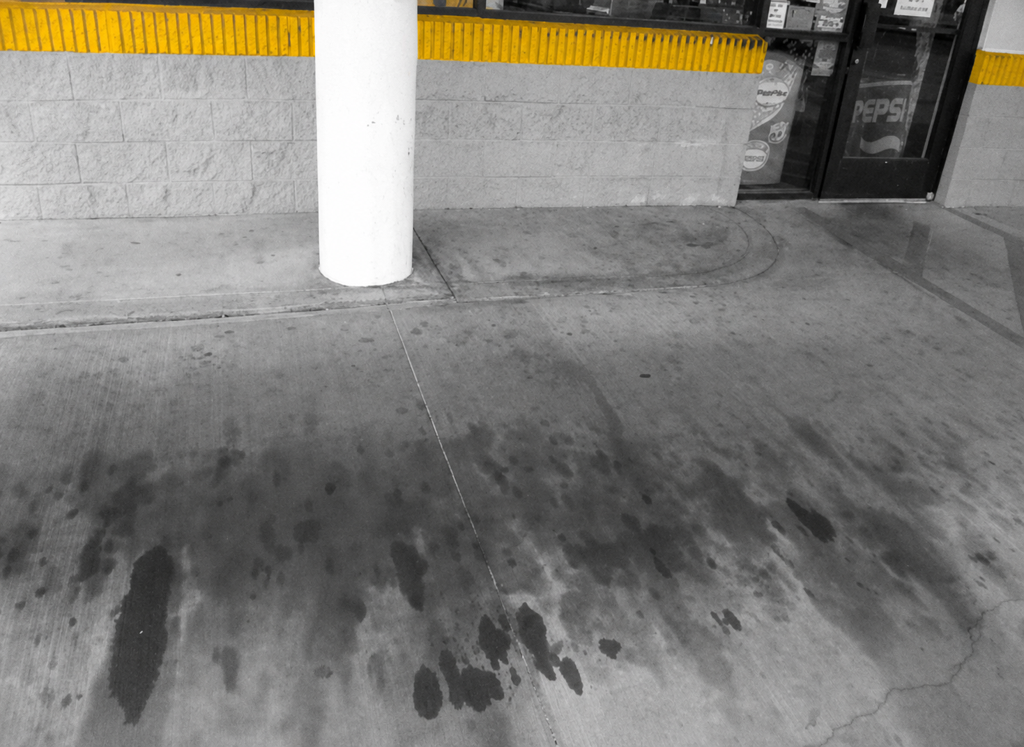 Concrete area with dark oil stains before EXIMO treatment